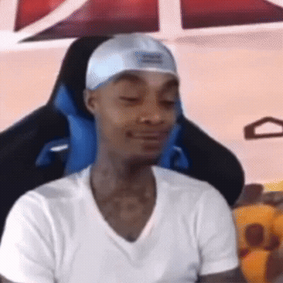 Man In Hat And White Shirt Sitting In Gaming Chair Eyes Closed GIF