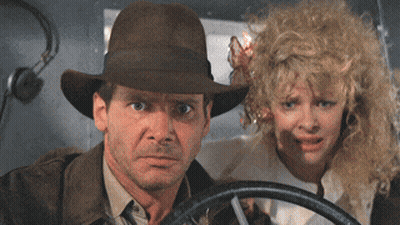 Man In Hat And Woman With Curly Hair Looking GIF