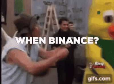 Man In Hat Asking When Binance Next To Yellow Duck GIF