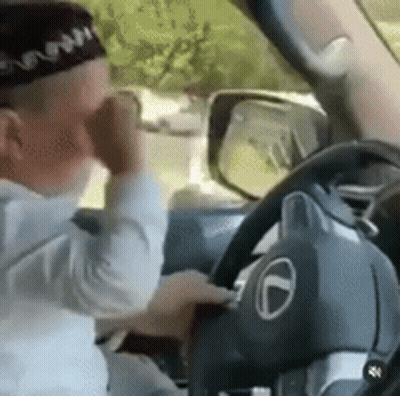 Man In Hat Driving Car Talking On Phone GIF