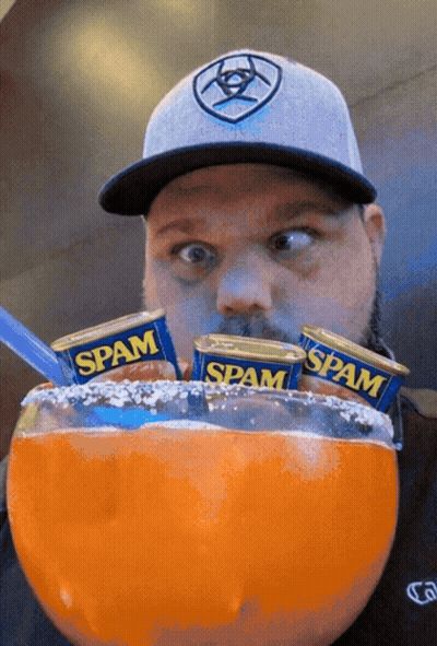 Man In Hat Eating Spam Cans GIF