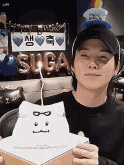 Man In Hat Holding Box With Candle GIF