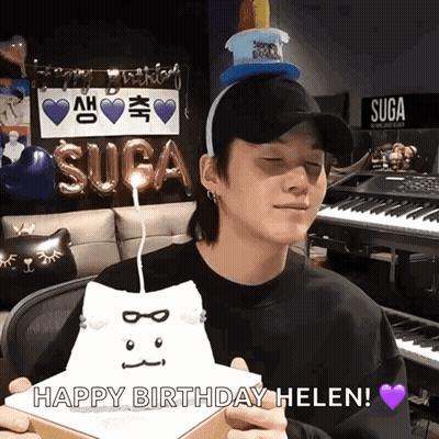 Man in Hat Holding Cat-Shaped Birthday Cake Saying Happy Birthday Helen