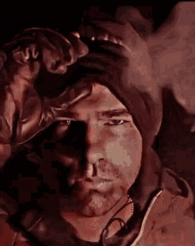 Man In Hat Holding Glove To Forehead GIF