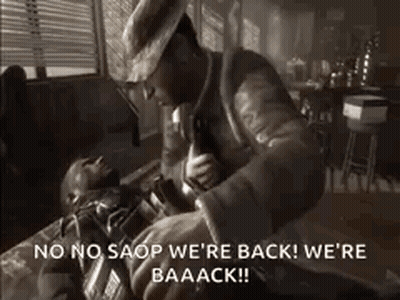 Man In Hat Holding Gun Over Man On Floor GIF