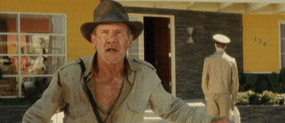 Man In Hat In Front Of Yellow House Number 138 GIF