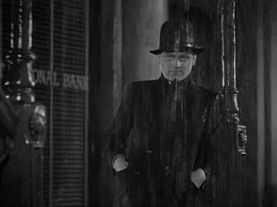 Man In Hat In Rain At National Bank GIF