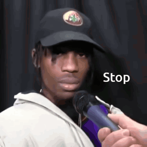 Man in Hat Interviewed With Stop Microphone