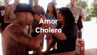 Man In Hat Kissing Woman On Forehead While Group Watches GIF