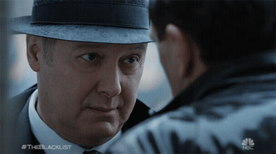 Man In Hat Looking At Man In Suit And Tie Blacklist GIF