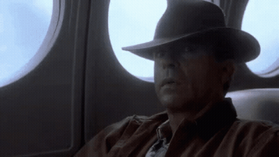 Man In Hat Looking Out Airplane Window GIF