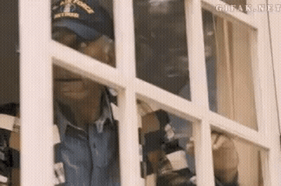 Man In Hat Looking Out Window GIF