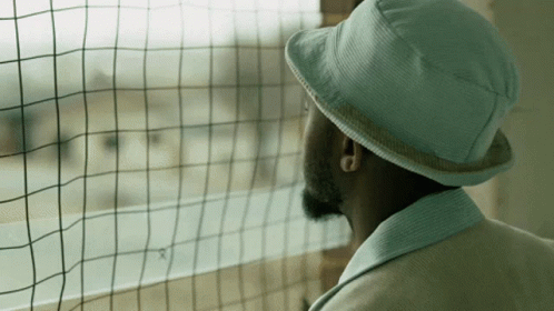Man In Hat Looking Out Window GIF