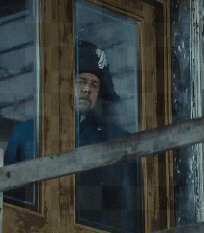 Man In Hat Looking Out Window GIF