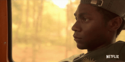 Man In Hat Looking Out Window With Netflix Logo GIF