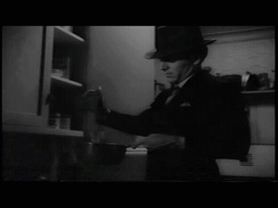 Man in Hat Opening Kitchen Cabinet
