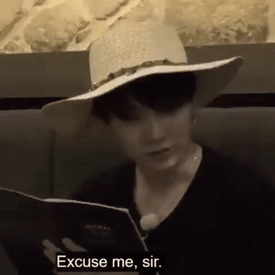 Man In Hat Reading Menu GIF