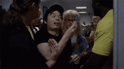 Man In Hat Saying Wayne's World Surrounded By People GIF