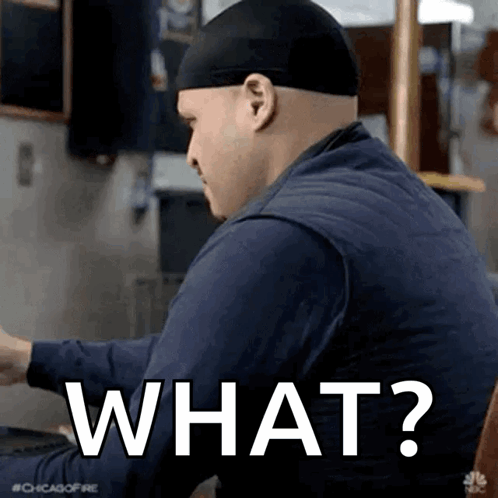 Man In Hat Saying What At Table GIF