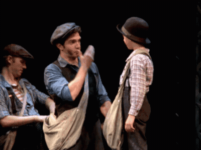 Man In Hat Shaking Hands With Boy In Overalls GIF
