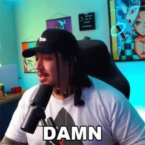 Man In Hat Sitting At Microphone With Damn Shirt GIF