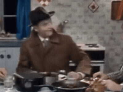 Man In Hat Sitting At Table GIF