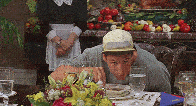 Man In Hat Sitting At Table With Plates And Glasses GIF
