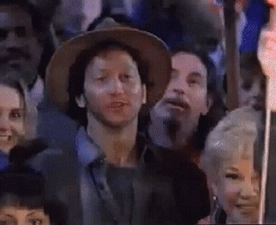 Man In Hat Sitting In Crowd GIF