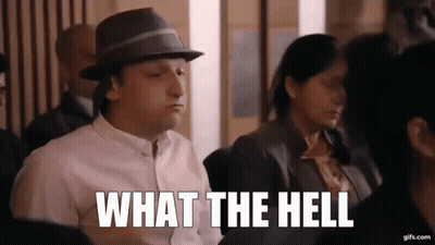 Man In Hat Sitting In Crowd Says What The Hell GIF