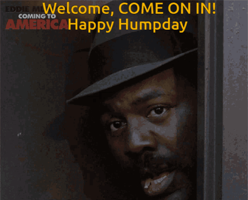Man In Hat Smiling In Front Of Welcome Come On In Sign GIF