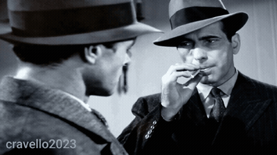 Man In Hat Smoking Cigarette Next To Man In Suit And Tie 2023 GIF