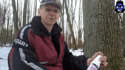 Man In Hat Standing Before Fence GIF