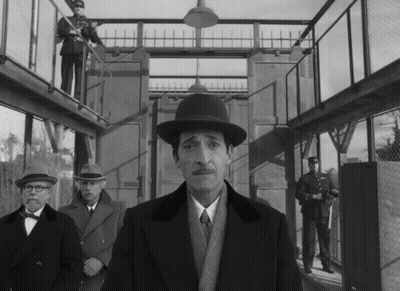 Man In Hat Standing Before Group GIF