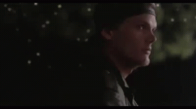 Man In Hat Standing In Dark Looking GIF