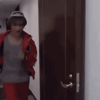Man In Hat Standing In Front Of Door GIF