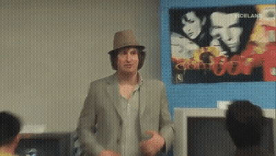 Man In Hat Standing In Front Of Iceland Poster GIF