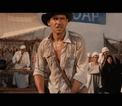 Man In Hat Standing In Front Of UAP Sign GIF