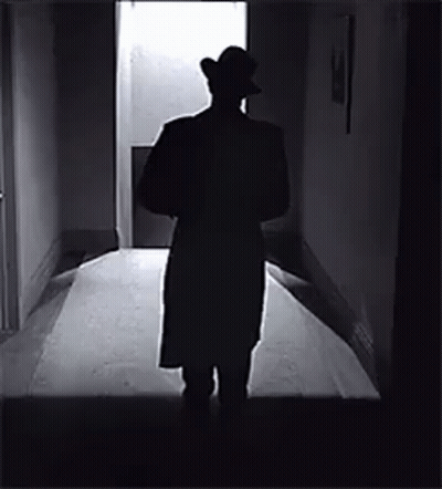 Man In Hat Standing In Hallway GIF