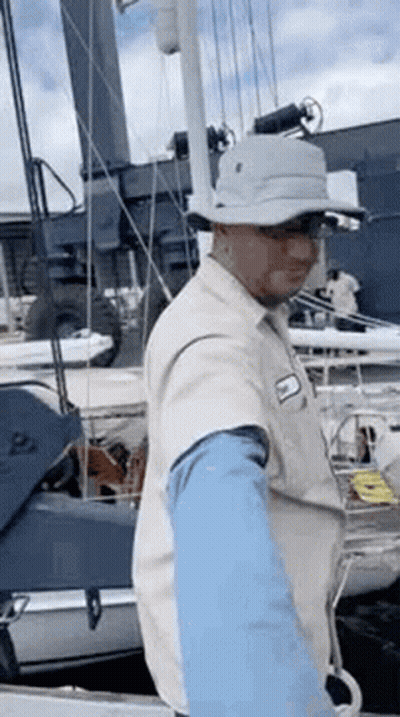 Man In Hat Standing On Boat GIF