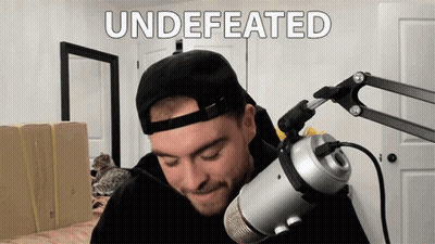 Man In Hat Stands At Microphone Saying Undefeated GIF