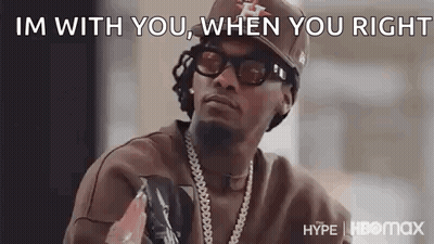 Man In Hat Sunglasses And Necklace Talking GIF