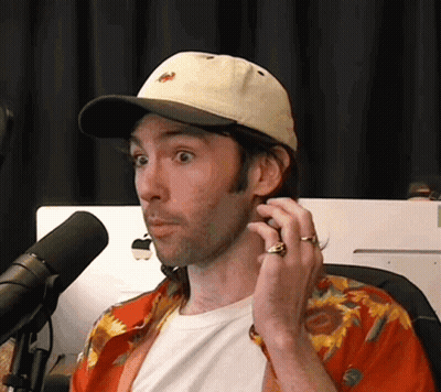 Man in Hat Talking Into Microphone