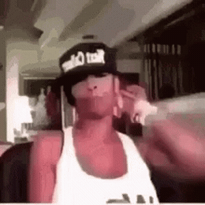 Man In Hat Talking On Cell Phone GIF