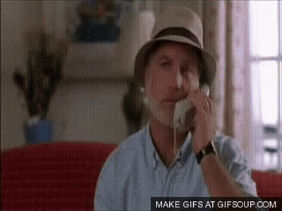 Man In Hat Talking On Phone Sitting On Couch GIF