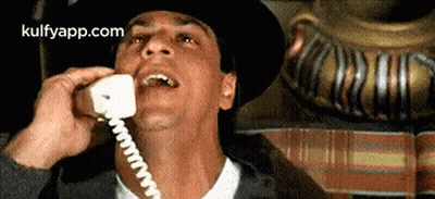 Man In Hat Talking On Phone GIF