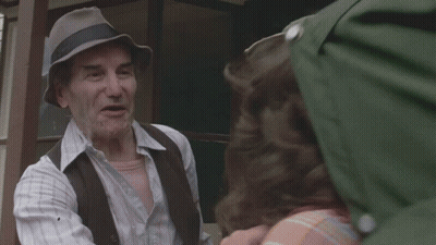 Man In Hat Talking To Man Outside House GIF