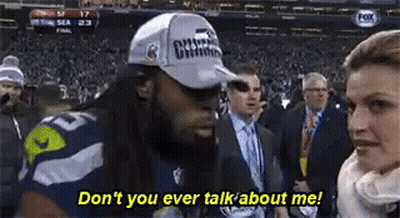 Man In Hat Talking To Woman In Crowd GIF