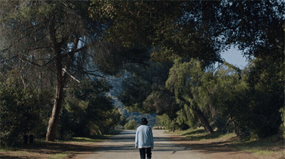 Man In Hat Walking On Dirt Road GIF