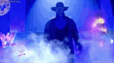 Man In Hat Walking Through Smokey Area With W Logo GIF
