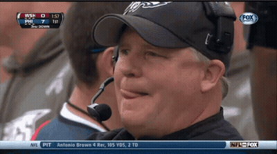 Man In Hat Watching Game On Fox With Microphone GIF